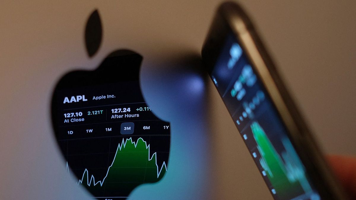 US-ECONOMY-STOCKS-APPLEThis illustration photo taken on May 24, 2021 shows the Apple stock market ticker symbol AAPL displayed on an iPhone screen and reflected in the logo of an iMac computer in Los Angeles. (Photo by Chris Delmas / AFP)