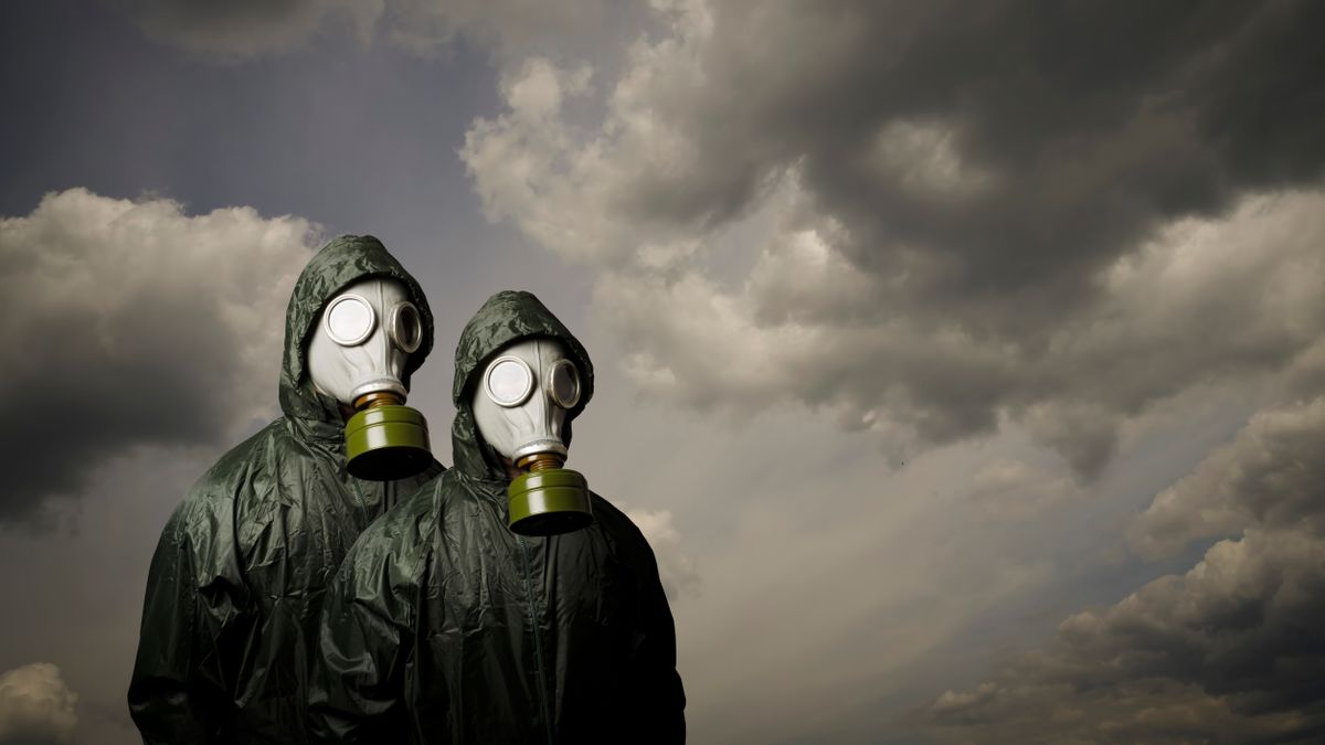 Gas,Masks.,Two,People,With,Gas,Masks,And,Dramatic,Sky