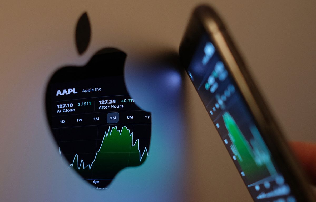 US-ECONOMY-STOCKS-APPLEThis illustration photo taken on May 24, 2021 shows the Apple stock market ticker symbol AAPL displayed on an iPhone screen and reflected in the logo of an iMac computer in Los Angeles. (Photo by Chris Delmas / AFP)