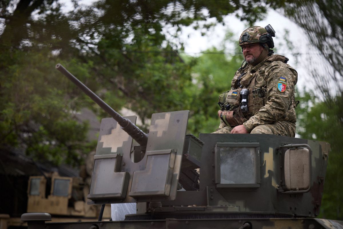 This handout photograph taken and released by the Ukrainian Presidential press-service on May 23, 2023 shows servicemen on guard during the visit of the President of Ukraine Volodymyr Zelensky (not pictured) to the forward positions of the Armed Forces of Ukraine in the Vugledar-Maryinka defense zone, Donetsk region, on the occasion of the Marine Day, amid the Russian invasion of Ukraine. 
