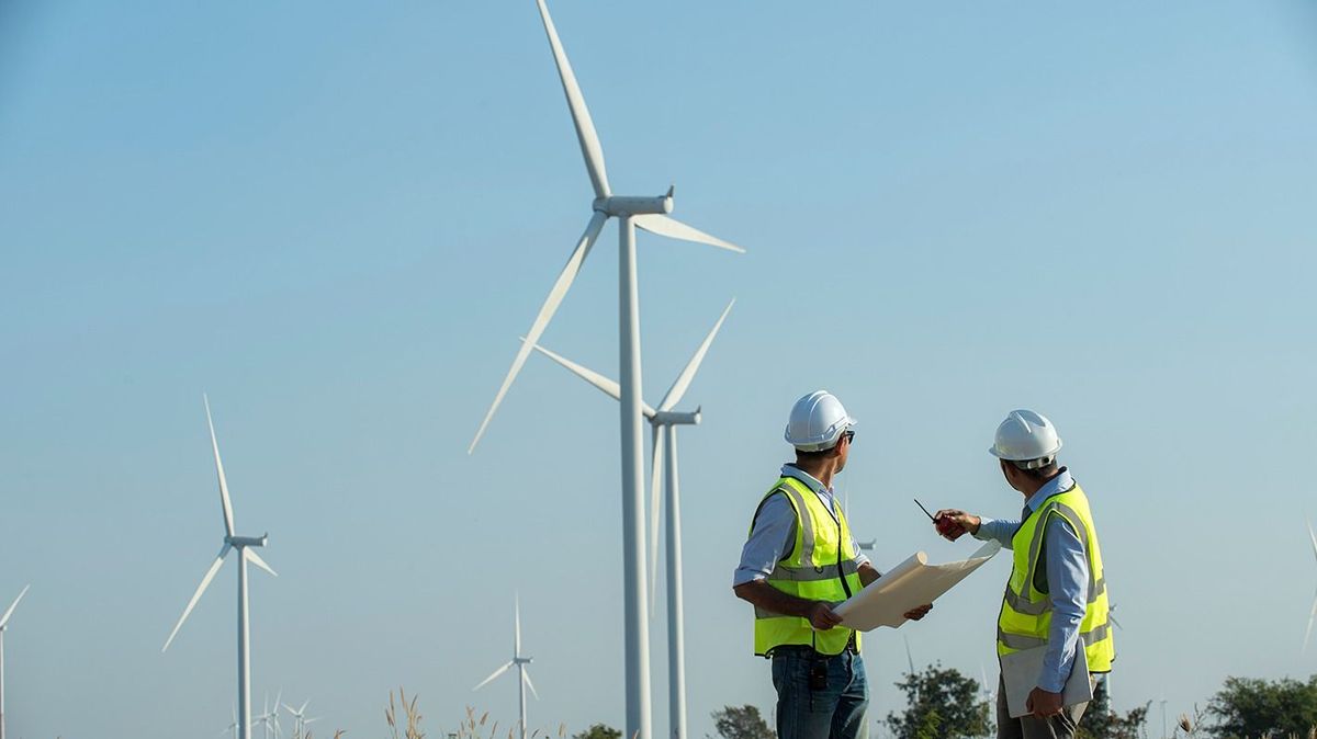 Back,View,Of,Two,Engineers,Discussing,Against,Turbines,On,Wind