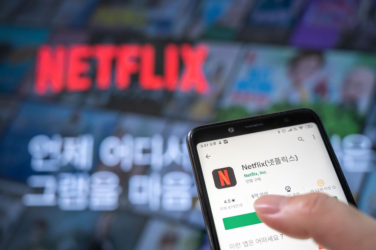 Seoul,,South,Korea,-,May,20,,2020:,Hands,To,Install
Seoul, south Korea - May 20, 2020: Hands to install the app with the Netflix screen and smartphone of the television.