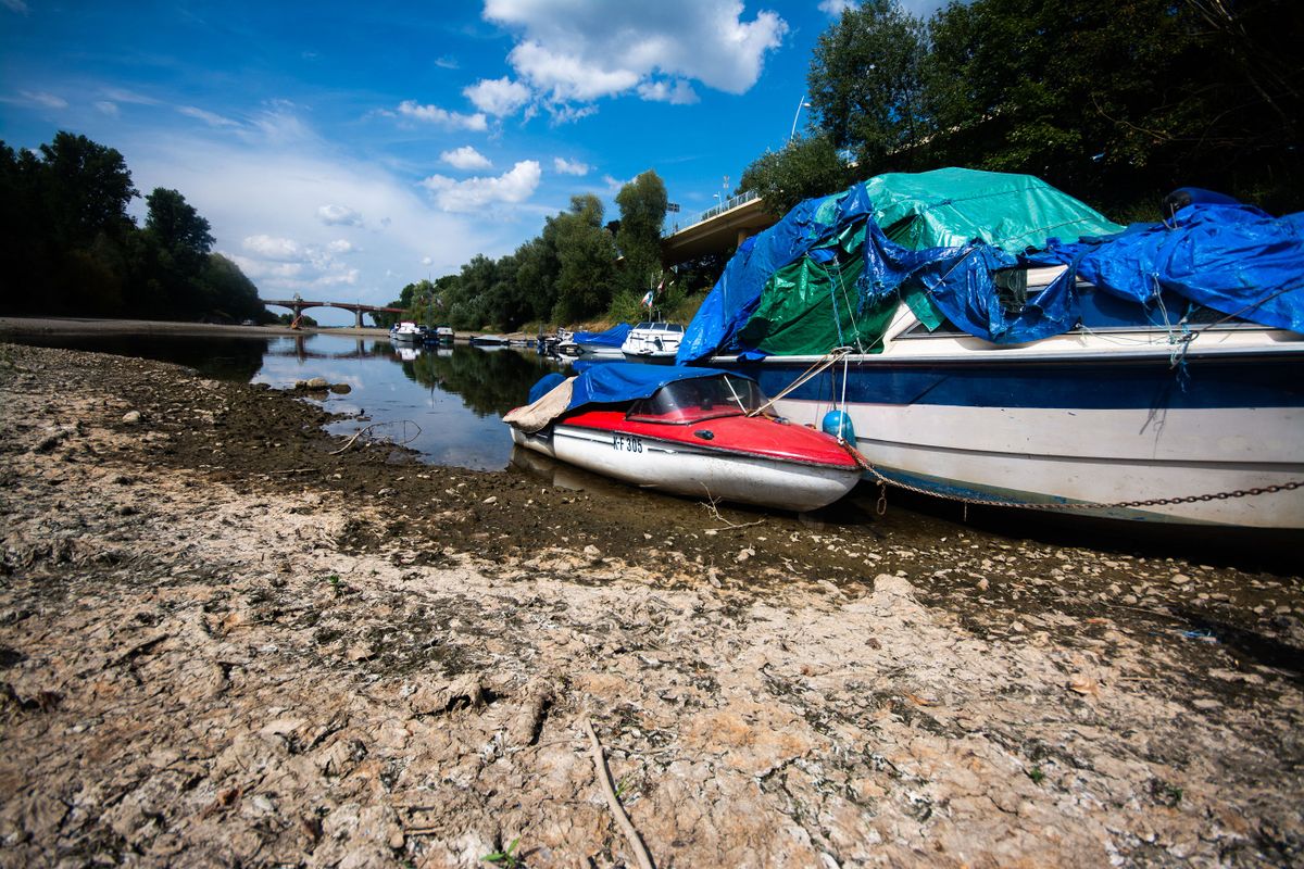 a boat is seen resting on  on partically dried up river bank of ohbach rivver which direct connect to Rhine river during the low water level of Rhine river in Bad Honnef, Germany on August 16, 2022