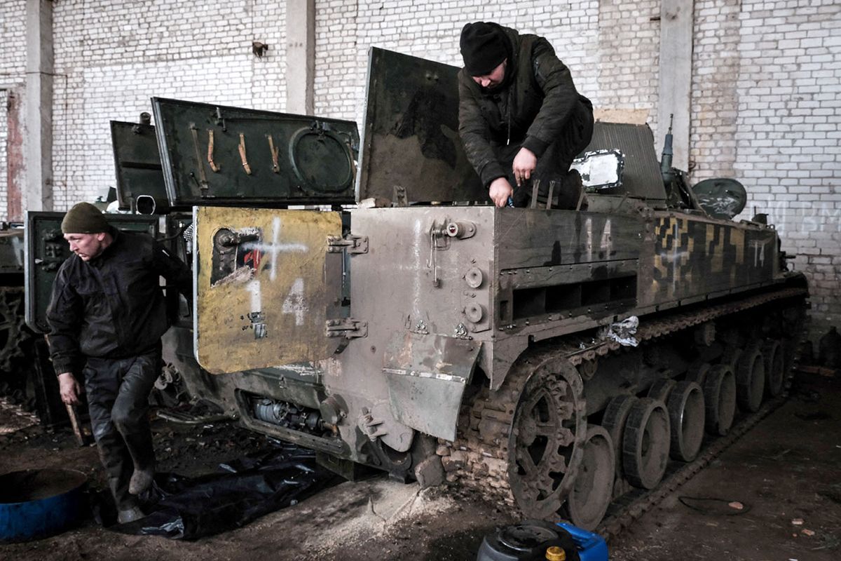 UKRAINE-RUSSIA-CONFLICT-WAR
Mechanics of the Ukrainian Army’s 14th Mechanised Brigade work to refurbish the captured Russian BMP-3 infantry fighting vehicle at the brigade's workshop in Kharkiv region on February 20, 2023, amid the Russian invasion of Ukraine. (Photo by YASUYOSHI CHIBA / AFP)