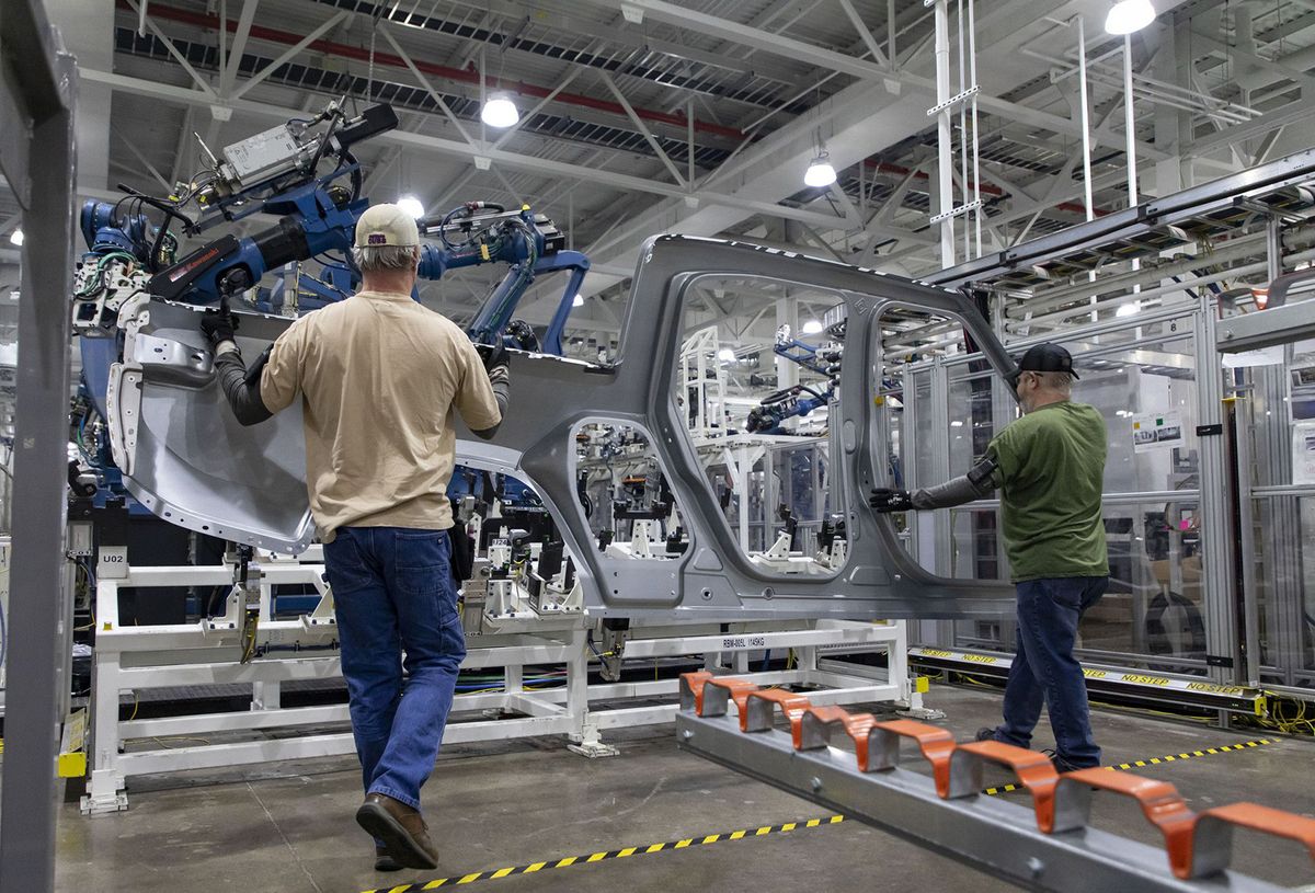BIZ-AUTO-RIVIAN-LAYOFFS-TB
Workers load a part as robotic equipment assembles R1T truck bodies in a marriage line on April 11, 2022, at the Rivian electric vehicle plant in Normal. (Brian Cassella/Chicago Tribune/Tribune News Service via Getty Images)