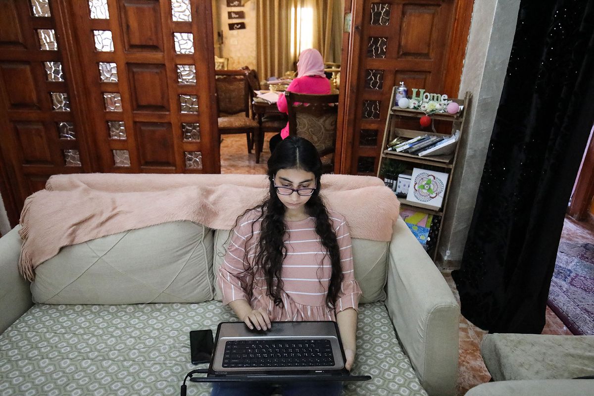 Family's one day of quarantine in Jerusalem
JERUSALEM - APRIL 15: Daughter Rodina (Front) studies as her mother Hedil El-Malabi (Rear), a Palestinian teacher, prepares notes for students while working from home as schools remain closed and curfew continues within measures against the coronavirus (COVID-19) in Jerusalem on April 15, 2020. Mostafa Alkharouf / Anadolu Agency (Photo by Mostafa Alkharouf / ANADOLU AGENCY / Anadolu Agency via AFP)