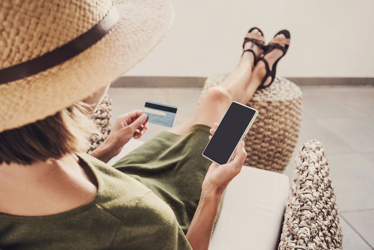 Young,Woman,On,Vacations,Using,Phone,And,Credit,Card.,Online