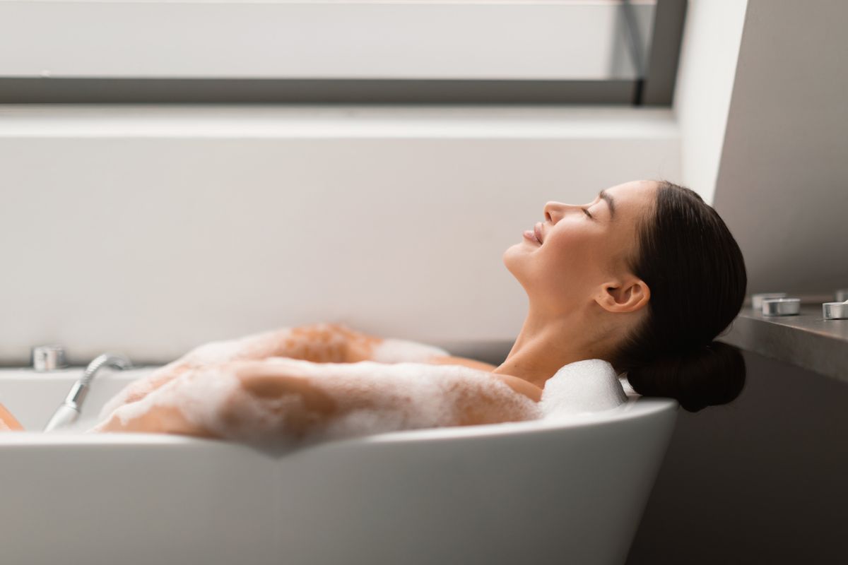 Relaxed,Female,Taking,Bath,With,Foam,Lying,In,Bathtub,In