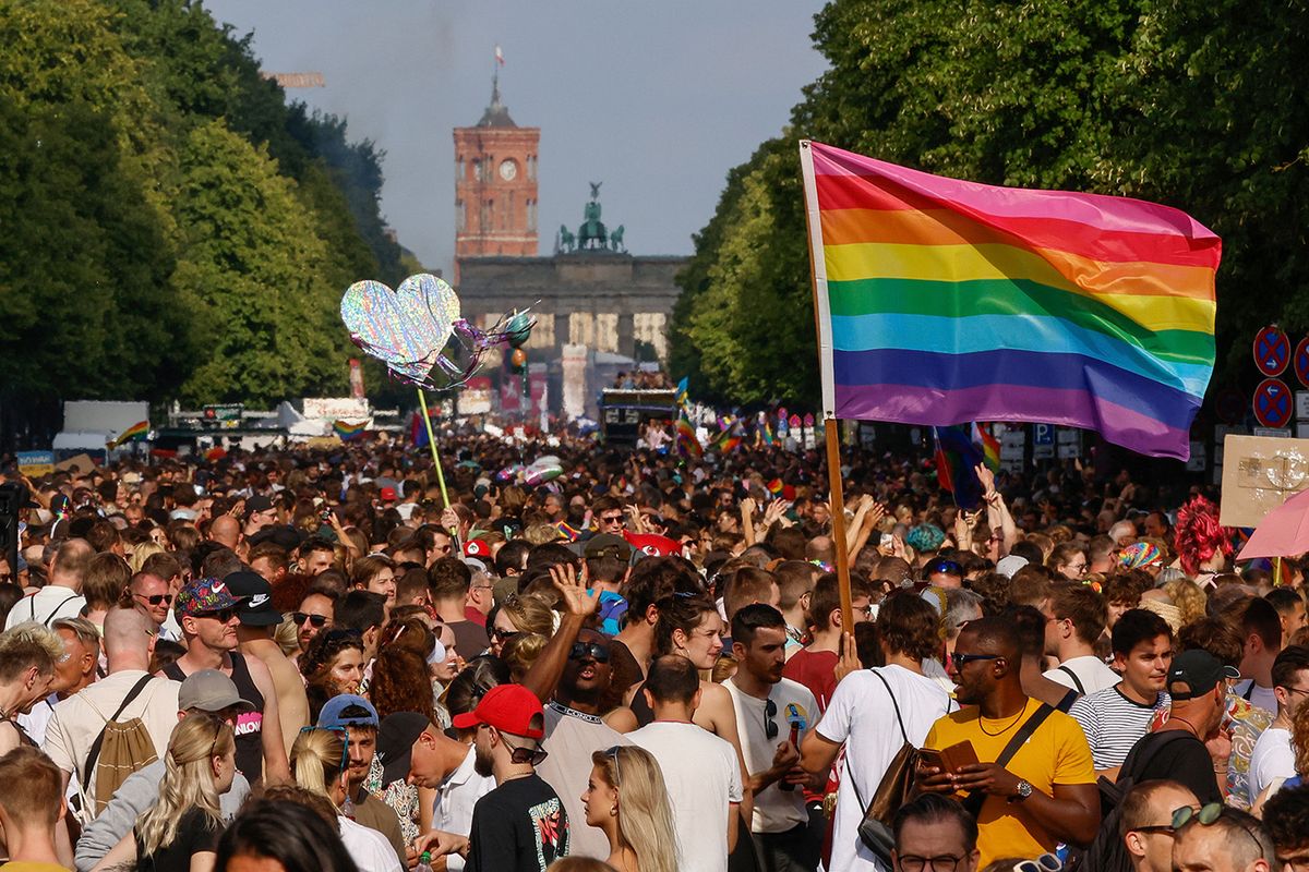 -GERMANY-PRIDE-CSD
People take part in the 44th Christopher Street Day (CSD) demonstration during Pride month in Berlin on July 23, 2022, with the Brandenburg Gate and City Hall in the background. Members of the LGBTIQA+ community and their allies take to the streets under the motto "United in Love! Agains Hate, War and Discrimination”. Christopher Street Day is in memory of the Stonewall Riots, the first big uprising of homosexuals against police assaults in New York City on June 27, 1969. (Photo by DAVID GANNON / AFP)