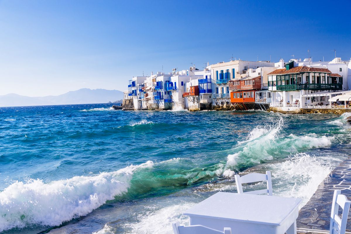 Soft afternoon light and breaking waves in a famous Little Venice quarter of Mykonos town, Mykonos island, Greece
