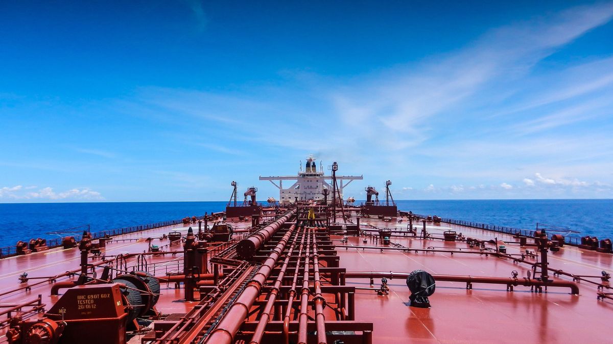 A large red crude oil tanker is sailing in the Indian Ocean