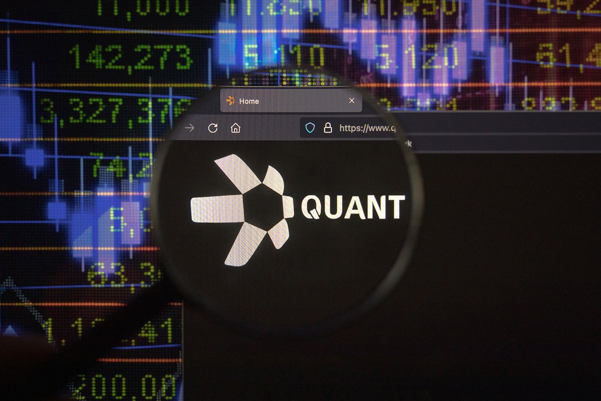KAUFBEUREN, GERMANY - JANUARY 22, 2022. Quant crypto company logo on a website, seen on a computer screen through a magnifying glass.