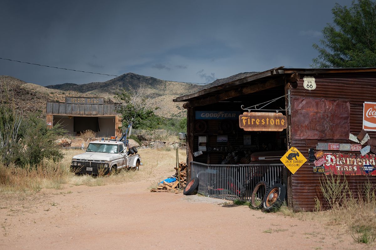 Arizona, United States - October 10 2022 - Old car mechanic shop on the desert road, there is a sixth generation Ford F-Series tow truck