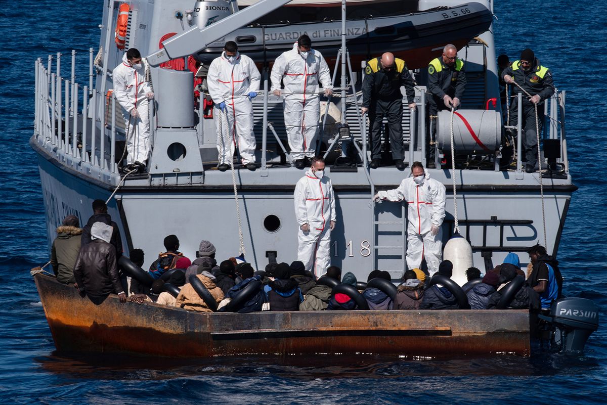 Italian Mediterranean Migrant Boat Rescue
LAMPEDUSA, ITALY - 2023/02/21: The crew of a Guardia di Finanza boat rescuing 40 to 50 migrants. At around 7:30 a.m. on Tuesday, 21 February, 40 sub-Saharan migrants were rescued from a precarious metal boat. There were 20 minors onboard, 18 of whom were unaccompanied by adults. (Photo by Ximena Borrazas/SOPA Images/LightRocket via Getty Images)