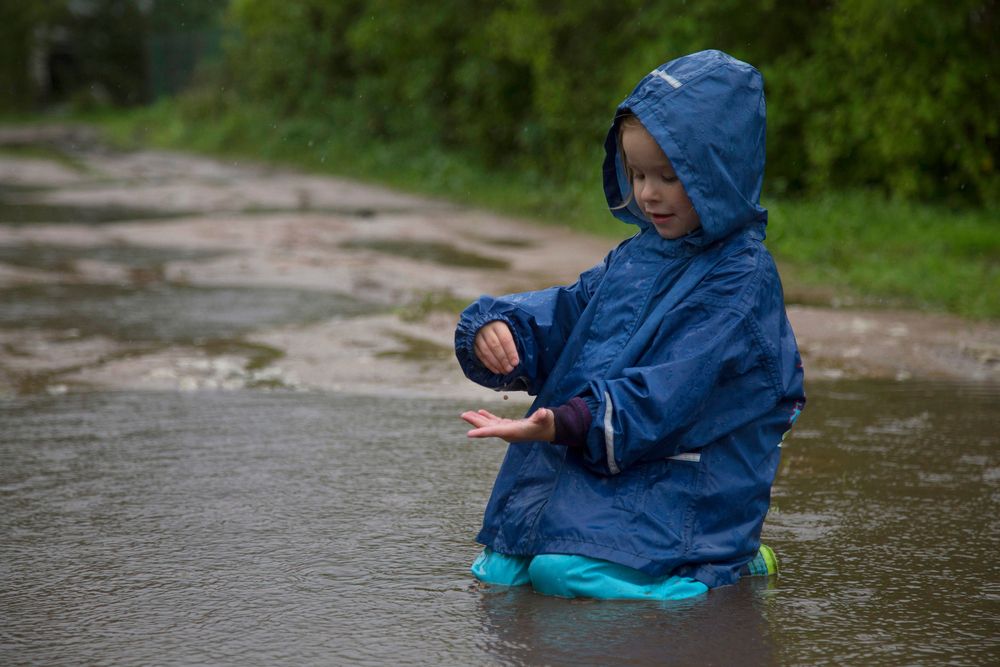 Girl,Playing,In,A,Puddle,In,The,Rain.