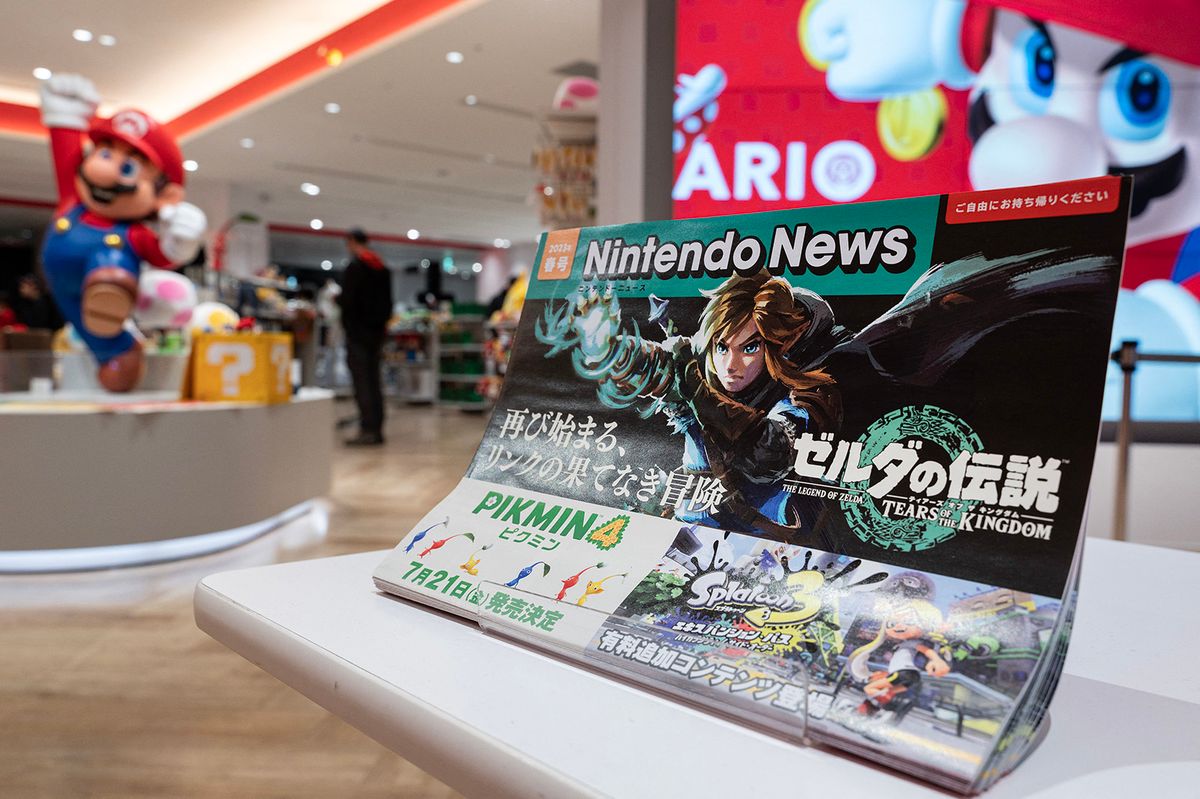This photo taken on May 8, 2023 shows a newsletter for visitors highlighting the new game "Tears of the Kingdom" for Japanese gaming giant Nintendo's long-running "Legend of Zelda" game series, at the entrance to company's official store in Tokyo's Shibuya district. - Nintendo, who will report net annual earnings later on May 9, will also release the latest instalment in its long-running "Legend of Zelda" game series, titled "Tears of the Kingdom", for the Switch on May 12. (Photo by Richard A. Brooks / AFP)