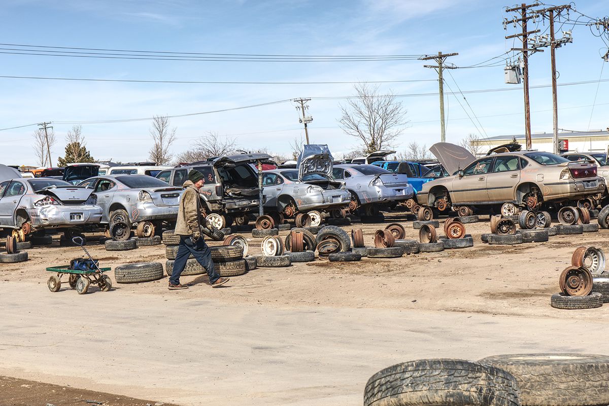 Greeley, Colorado, USA - February 27, 2020. Shade-tree mechanics search through wrecked vehicles for parts to repair their own vehicles.  Salvage yards  are recyclers.