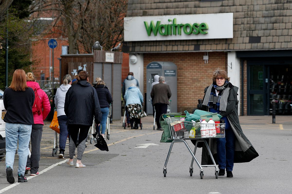 Shoppers visit a Waitrose supermarket in Frimley, south west of London on March 29, 2020, as life in Britain continues during the nationwide lockdown to combat the novel coronavirus pandemic. Prime Minister Boris Johnson warned Saturday the coronavirus outbreak will get worse before it gets better, as the number of deaths in Britain rose 260 in one day to over 1,000. The Conservative leader, who himself tested positive for COVID-19 this week, issued the warning in a leaflet being sent to all UK households explaining how their actions can help limit the spread. "We know things will get worse before they get better," Johnson wrote. (Photo by Adrian DENNIS / AFP)