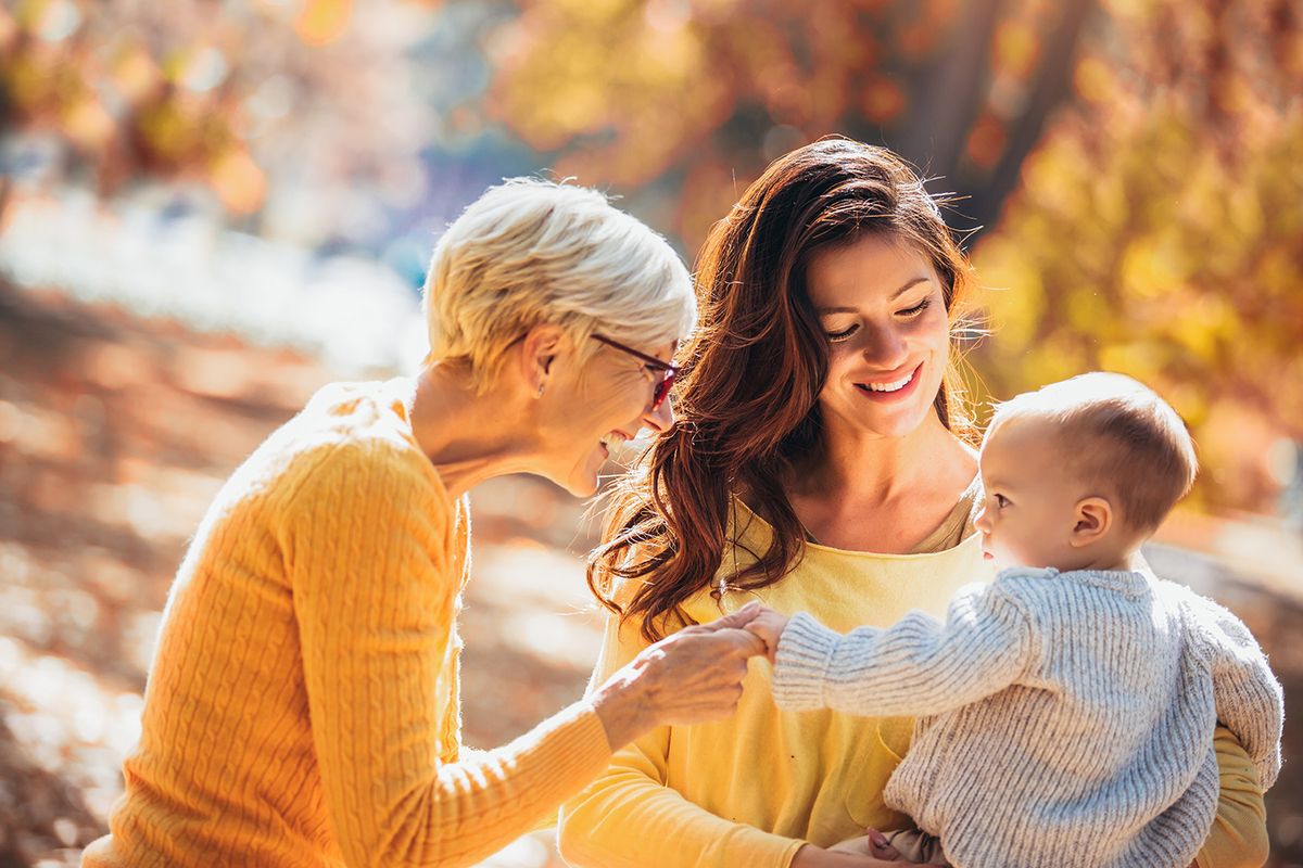 Grandmother,And,Mother,Smiling,At,Baby,In,Autumn,Park.
