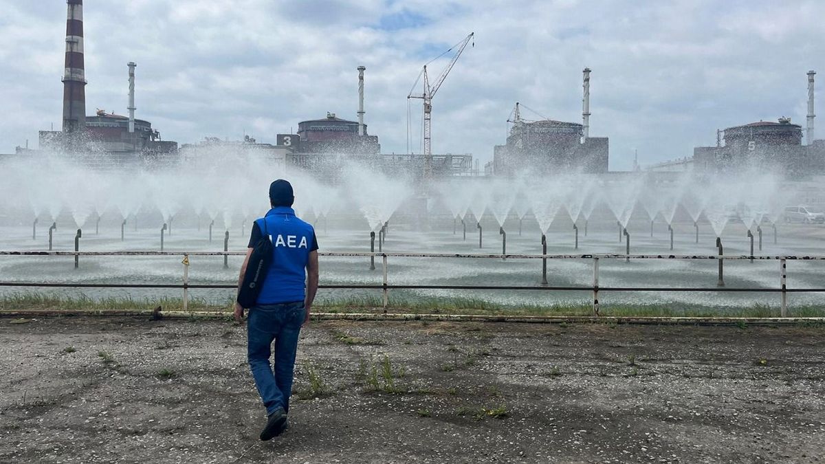 This handout photo taken and retrieved from the imagebank of International Atomic Energy Agency (IAEA) on June 15, 2023 shows a member of the agency walking near the Zaporizhzhia Nuclear Power Plant in Enerhodar, Zaporizhzhia Oblast, Ukraine during an official visit of the IAEA Director General Grossi with his team to the nuclear power plant and its surrounding area. The safety of Europe's largest nuclear power plant, located in Ukraine's southeastern region of Zaporizhzhia, has been a concern since Russian forces seized it over a year ago. Those concerns have been exacerbated by the breach of the Kakhovka dam that provided the cooling water for the plant. (Photo by Handout / International Atomic Energy Agency (IAEA) / AFP) / RESTRICTED TO EDITORIAL USE - MANDATORY CREDIT "AFP PHOTO / IAEA " - NO MARKETING - NO ADVERTISING CAMPAIGNS - DISTRIBUTED AS A SERVICE TO CLIENTS