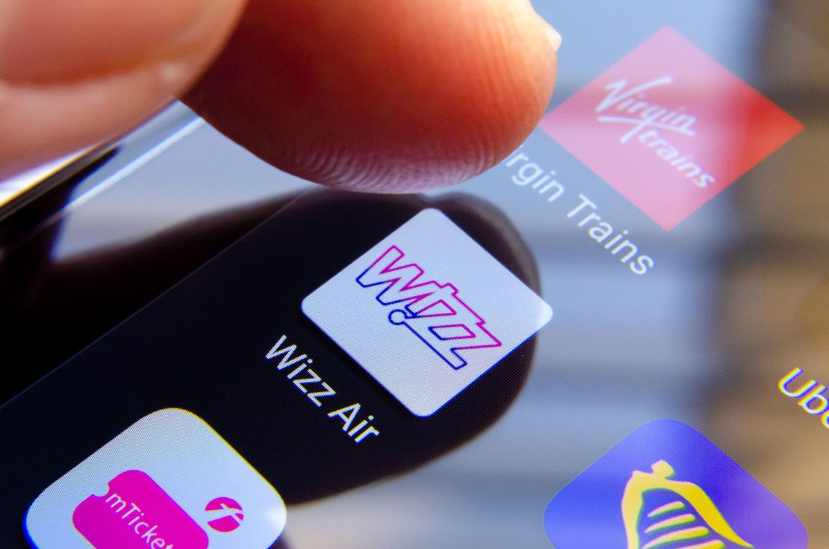 Stone,,Staffordshire,/,Uk,-,September,20,2019:,Wizz,Air
Stone, Staffordshire / UK - September 20 2019: Wizz Air app on the screen and a finger about to choose it. It is surrounded by Ryinair, Virgin Trains apps. Close up photo with shallow depth of field.