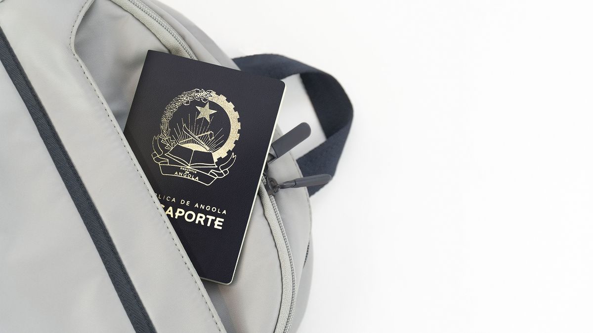 Angola,Passport,On,A,Grey,Travel,Bag,With,White,Background