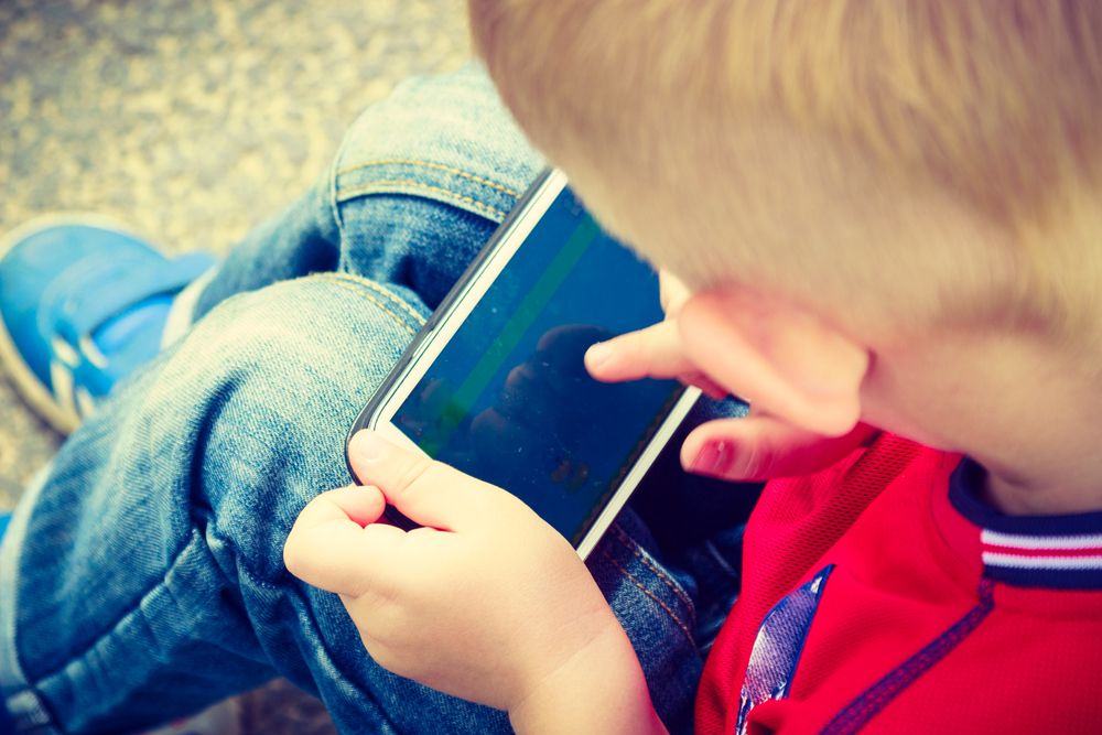 Little,Boy,Child,Kid,Playing,Games,On,Smartphone,Mobile,Phone