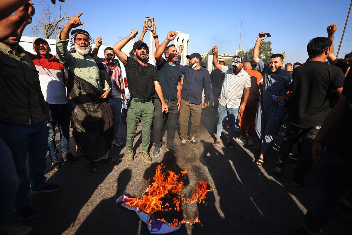 IRAQ-SWEDEN-RELIGION-KORANSupporters of Shiite Muslim leader Moqtada Sadr burn a rainbow flag outside the Swedish embassy in Baghdad, after they breached the building over the burning of the Koran by an Iraqi living in Sweden, on June 29, 2023. The demonstrators, entered the building and remained inside for about 15 minutes before leaving peacefully as security forces deployed. (Photo by Ahmad AL-RUBAYE / AFP)