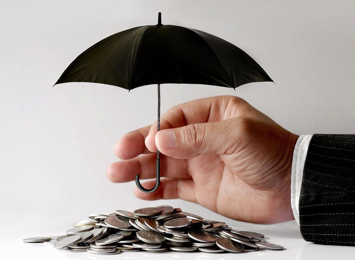 Businessman,Protecting,Coins,With,Umbrella.,Financial,Safety,Concept.
Businessman Protecting Coins With Umbrella. Financial safety Concept.