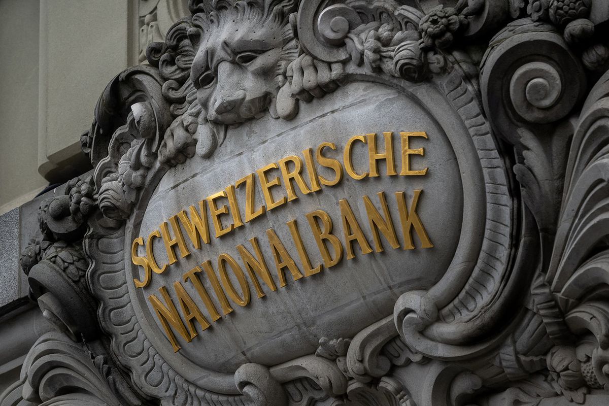 A sign of the Swiss National Bank (SNB) is seen on its headquarters ahead of a press conference in Bern on December 15, 2022. The Swiss central bank on December 15, 2022 raised its key interest rate by 50 basis points to 1%, continuing to tighten monetary policy despite the recent deceleration in Swiss inflation. (Photo by Fabrice COFFRINI / AFP)