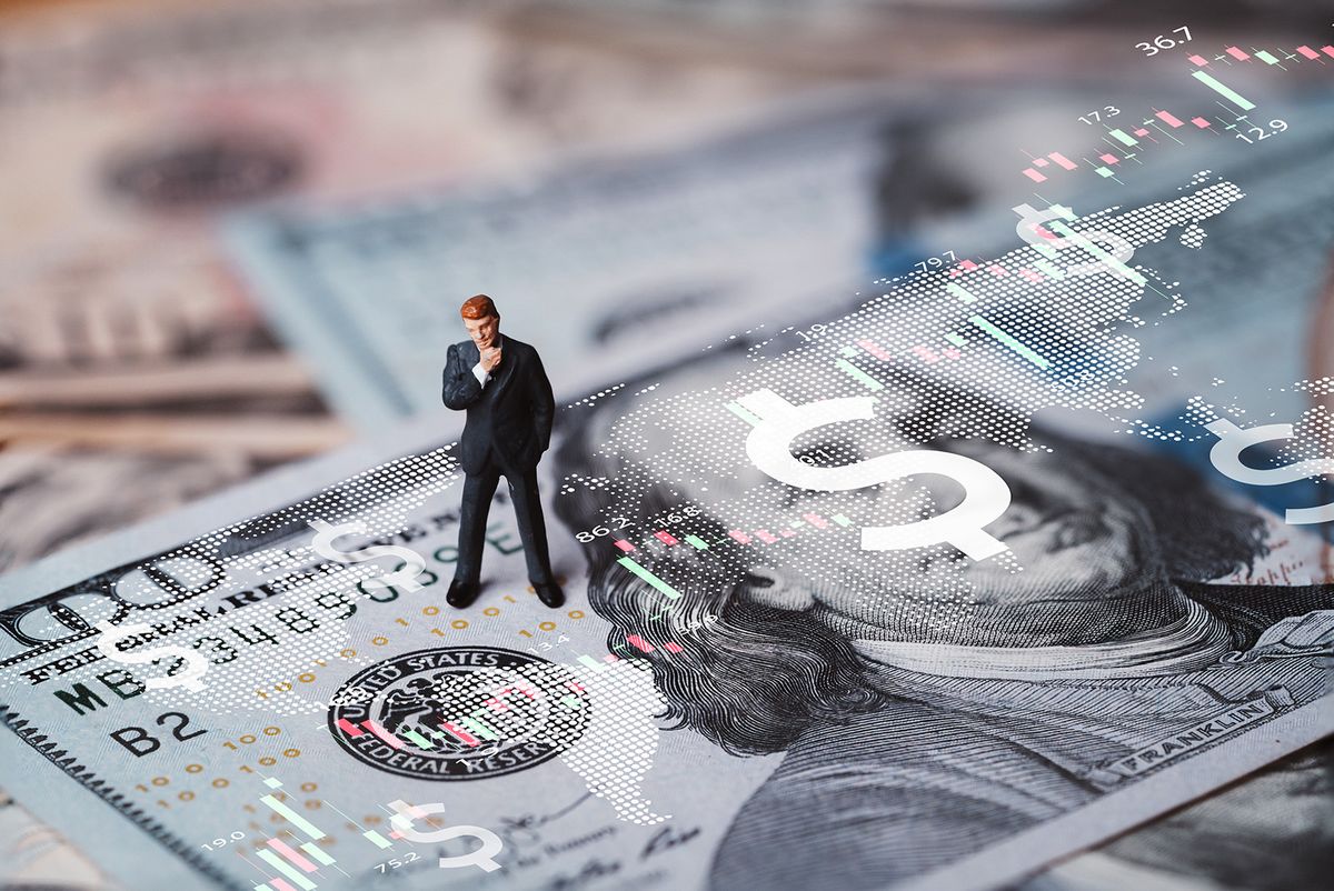 Businessman,Miniature,Figure,Standing,On,Usd,Banknote,With,Stock,Market
Businessman miniature figure standing on USD banknote with stock market chart graph for currency exchange of global trade forex and Fed increase interest rate to stop inflation concept.