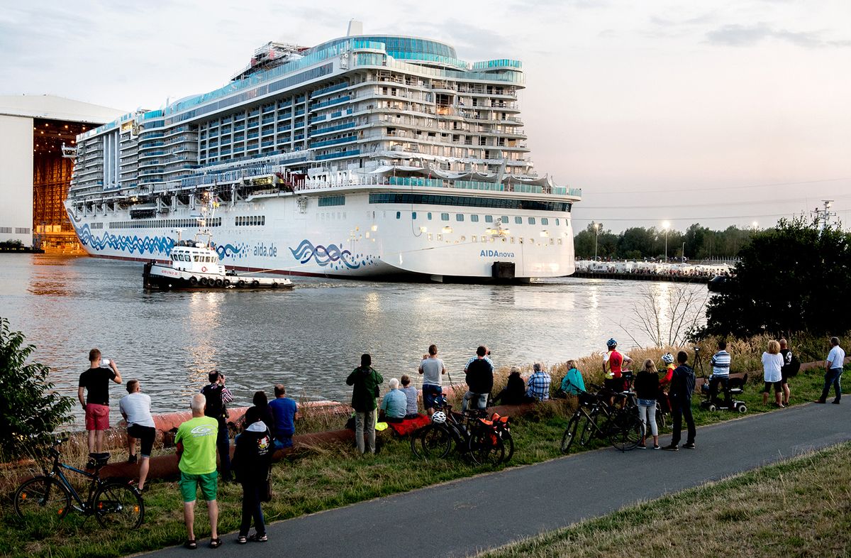 Undocking the AIDAnova
21 August 2018, Germany, Papenburg: Tugs pull the new cruise ship "AIDAnova" out of the covered hangar of the Meyer shipyard. The ocean liner AIDA Cruises, which is powered by liquid gas, was successfully undocked in the evening. Photo: Hauke-Christian Dittrich/dpa (Photo by Hauke-Christian Dittrich / DPA / dpa Picture-Alliance via AFP)