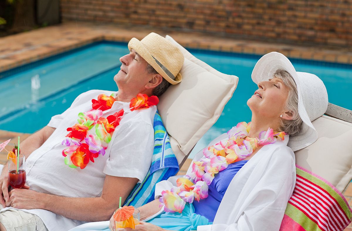 Retired,Couple,Sleeping,Beside,The,Swimming,Pool