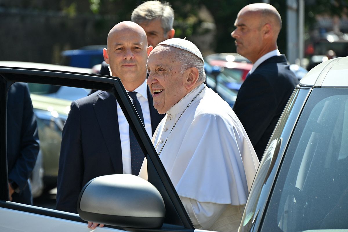 Pope Francis smiles as he exits his car while arriving at The Vatican's Porta del Perugino gate on June 16, 2023 after being discharged from the Gemelli hospital in Rome, where he underwent abdominal surgery last week. (Photo by Filippo MONTEFORTE / AFP)