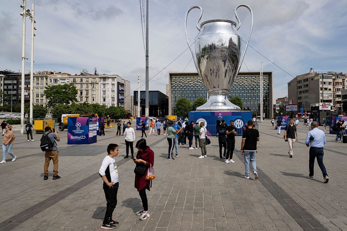 FBL-EUR-C1-FEATUREPedestrians walk around an inflatable model of the UEFA Champions League trophy, as the Taksim Mosque is seen in the background, on Taksim Square in Istanbul, on June 8, 2023. Manchester City will play Inter Milan in the UEFA Champions League final at the Ataturk Olympic Stadium in Istanbul on June 10, 2023. (Photo by Yasin AKGUL / AFP)