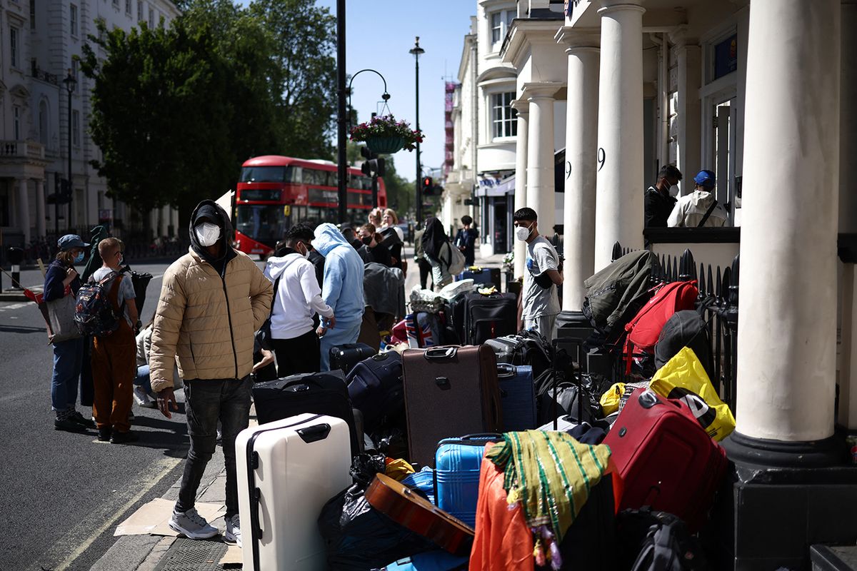 BRITAIN-EUROPE-MIGRANTSA group of migrants with their luggage, stage a protest outside their accomodation in west London on June 2, 2023, as they complain about living conditions. (Photo by HENRY NICHOLLS / AFP)