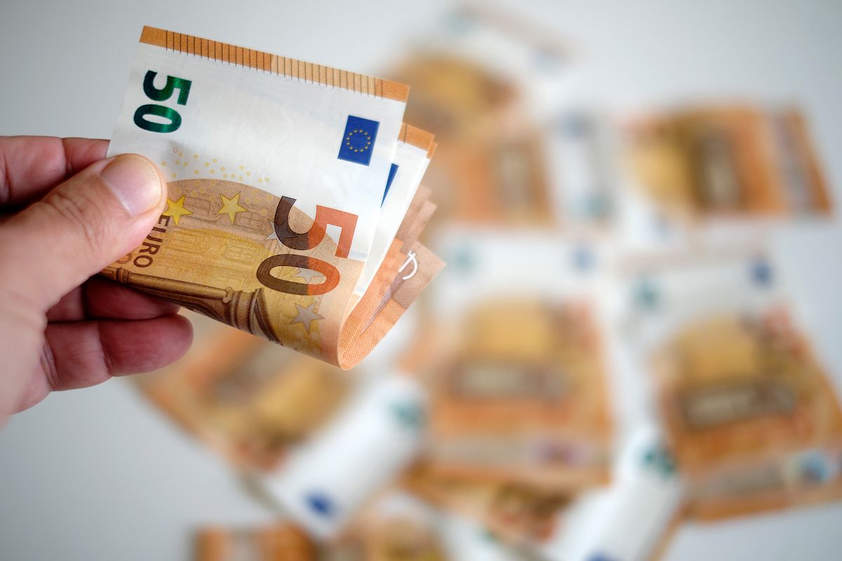 Wad,Of,50,Euro,Bills,Taken,By,Hand