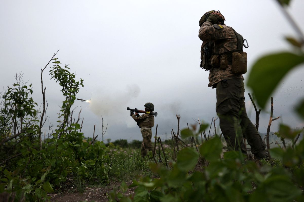 Ukrainian soldiers of the 28th Separate Mechanized Brigade fire a grenade launcher at the front line near the town of Bakhmut, Donetsk region, on June 17, 2023, amid the Russian invasion of Ukraine. (Photo by Anatolii STEPANOV / AFP)