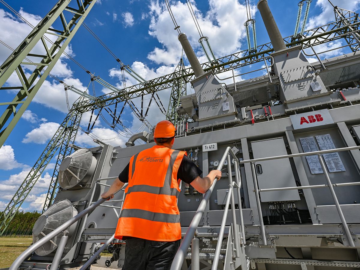 Commissioning of Altdöbern substation
08 June 2022, Brandenburg, Altdöbern: Henrik Schulz, operations foreman for substation technology from the company 50 Hertz, stands in front of a transformer in the new Altdöbern substation. On the same day, Mitnetz Strom and 50 Hertz commissioned the new Altdöbern substation and the 110 kilovolt connection line to the Großräschen substation. The construction costs amounted to around 50 million euros. As an energy region in Brandenburg, Lusatia is in the midst of structural change. Renewable energies supplement electricity production from lignite and are expected to replace it completely by 2038. This also requires a new power grid infrastructure. The Altdöbern substation serves to integrate electricity from wind and solar energy from the region into the distribution and transmission grid. Photo: Patrick Pleul/dpa (Photo by PATRICK PLEUL / DPA / dpa Picture-Alliance via AFP)