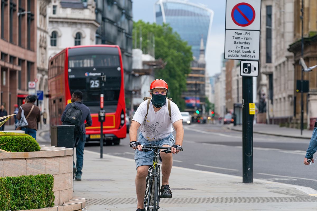 London,,England,-,June,3,,2020:,Elderly,Male,Cyclist,Riding
LONDON, ENGLAND - JUNE 3, 2020: Elderly male cyclist riding a bicycle in Holborn London wearing a face mask, glasses and crash helmet making eye contact during the COVID-19 pandemic - 003