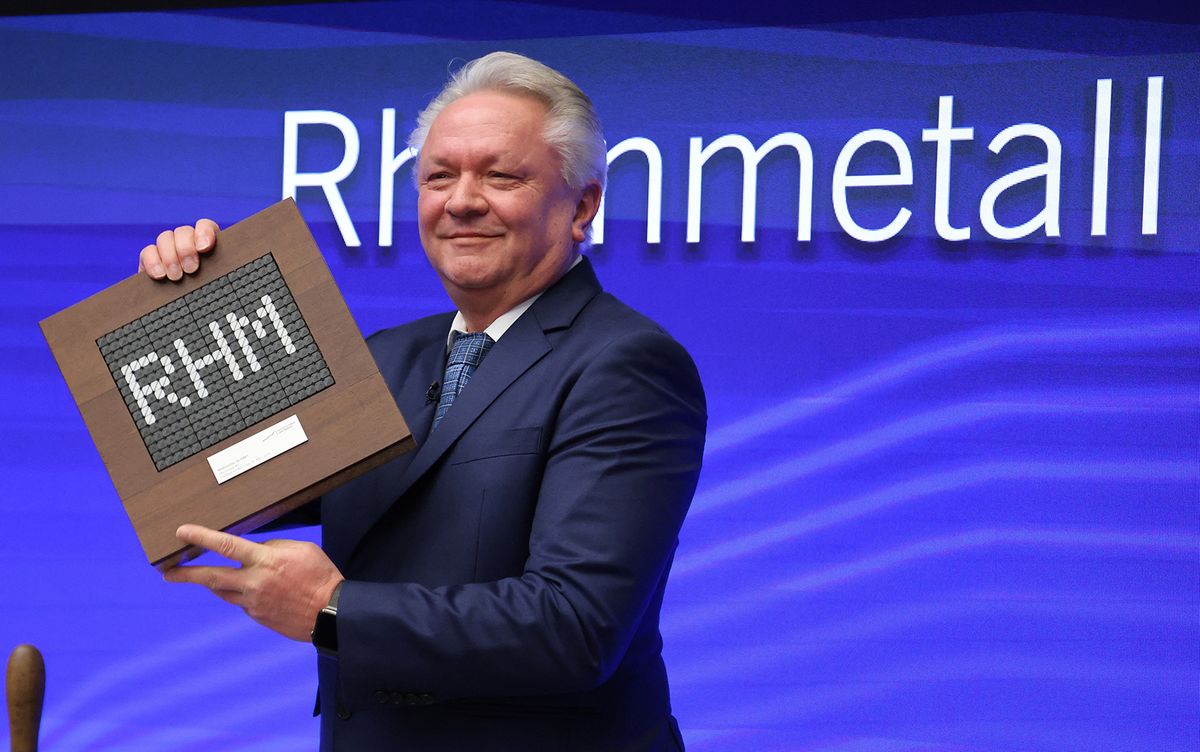 The CEO of German arms manufacturer Rheinmetall Armin Papperger poses with a plate showing the Rheinmetall abbreviation "RHM" during the company’s introduction to the German Stock Market Index DAX at the opening of the stock exchange in Frankfurt, Germany, on March 20, 2023. Rheinmetall will join Frankfurt's blue-chip DAX index, highlighting the improving fortunes of the country's weapons industry as the Ukraine war spurs demand. (Photo by Daniel ROLAND / AFP)