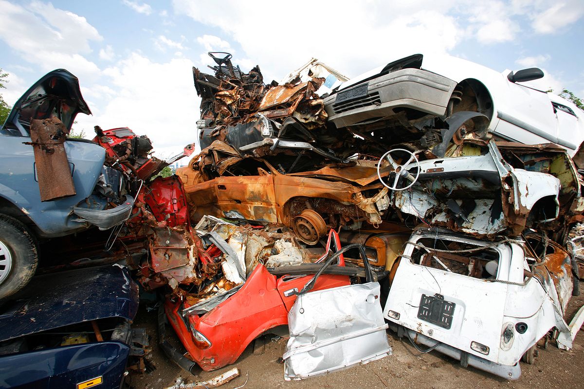 Cars,Piled,On,Top,Of,Each,Other,In,Junkyard Cars piled on top of each other in junkyard