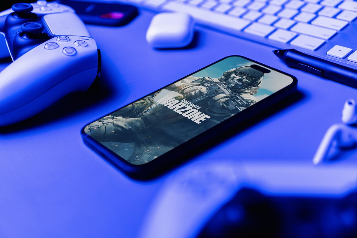 Cod,Call,Of,Duty,Game,App,On,The,Smartphone,Iphone
COD Call of Duty game app on the smartphone iPhone 14 Pro screen with PS5 video game controllers. Office environment. Low blue light. Rio de Janeiro, RJ, Brazil. June 23 2023.