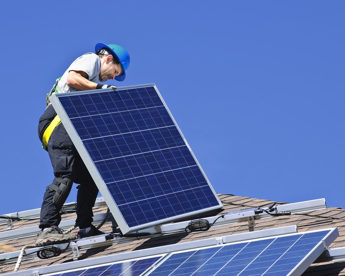 Man,Installing,Alternative,Energy,Photovoltaic,Solar,Panels,On,Roof
Man installing alternative energy photovoltaic solar panels on roof