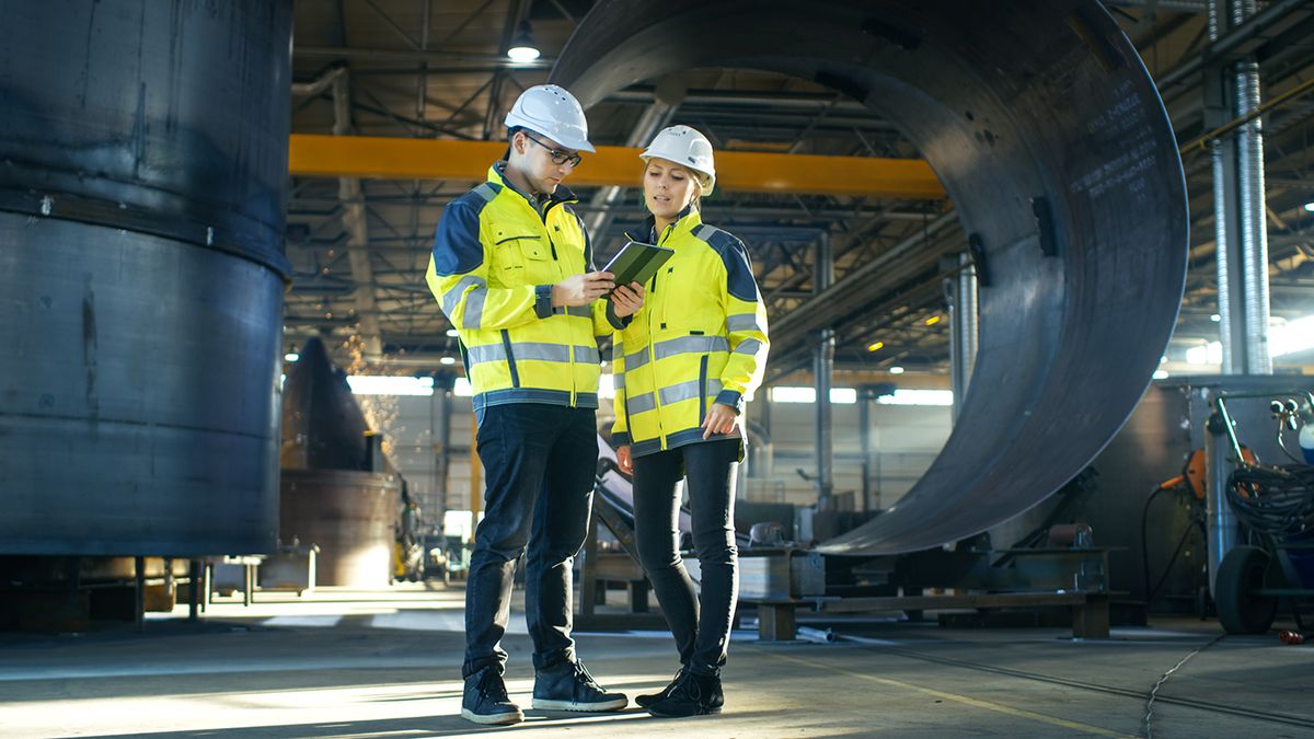 Male,And,Female,Industrial,Engineers,In,Hard,Hats,Discuss,New