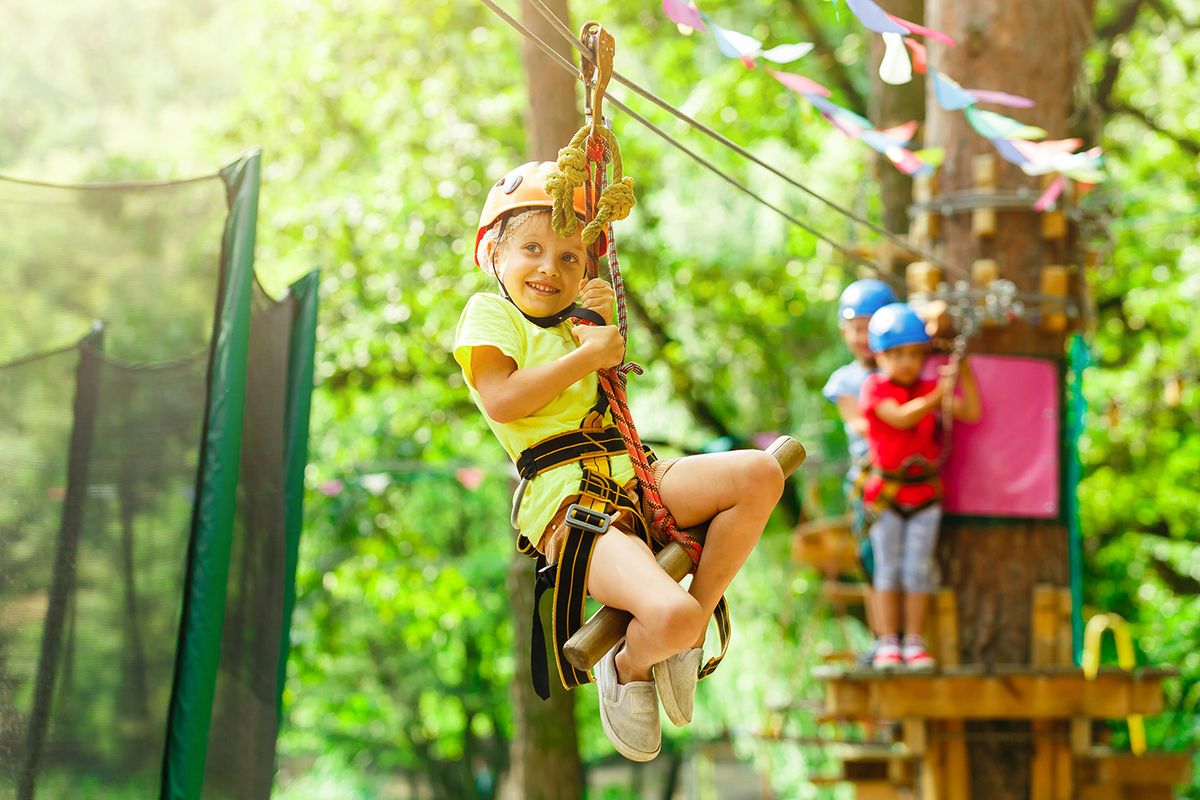 Brave,Young,Girl,In,Helmet,Climbs,On,Tree,Tops,In