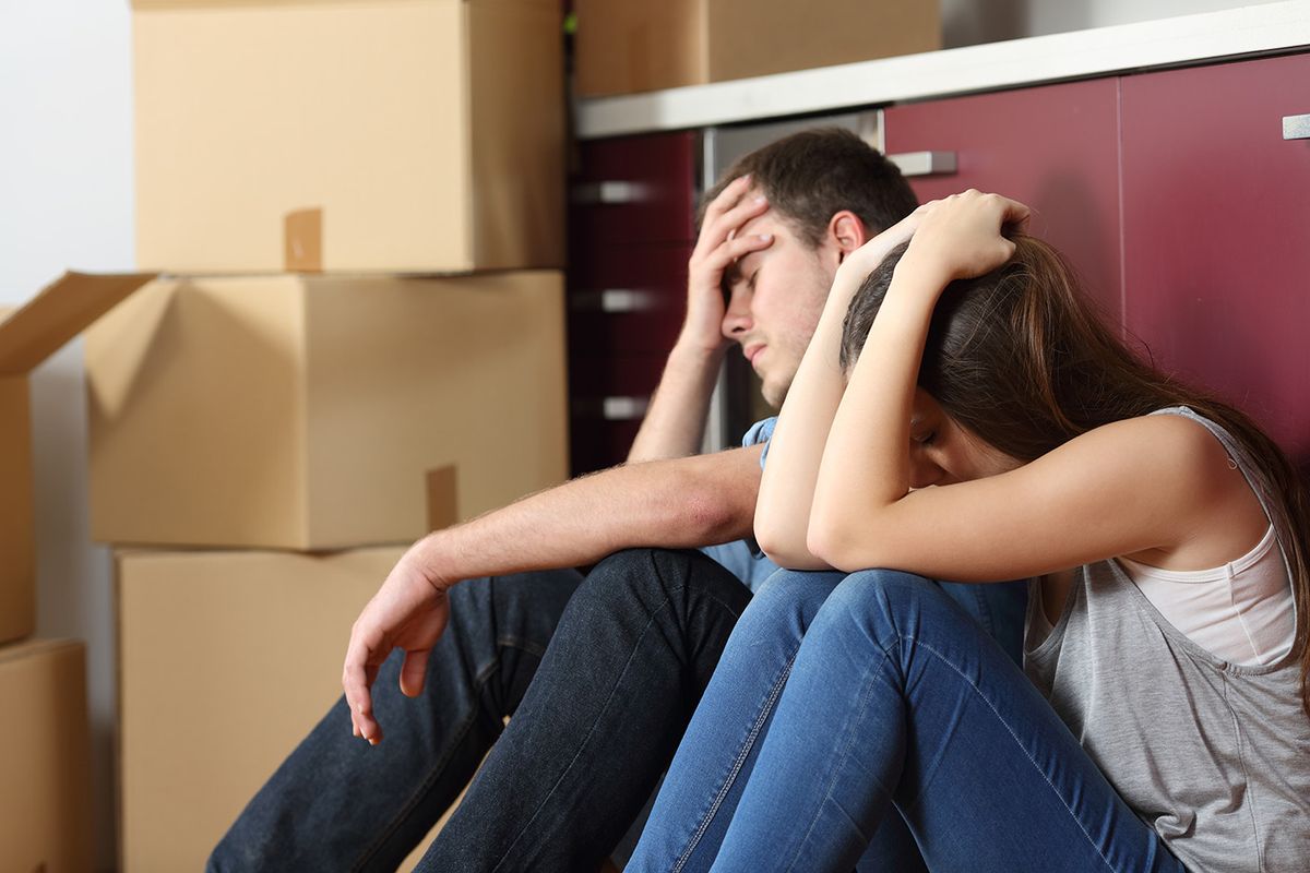 Angry,Evicted,Couple,Worried,Moving,House,Sitting,On,The,Floor