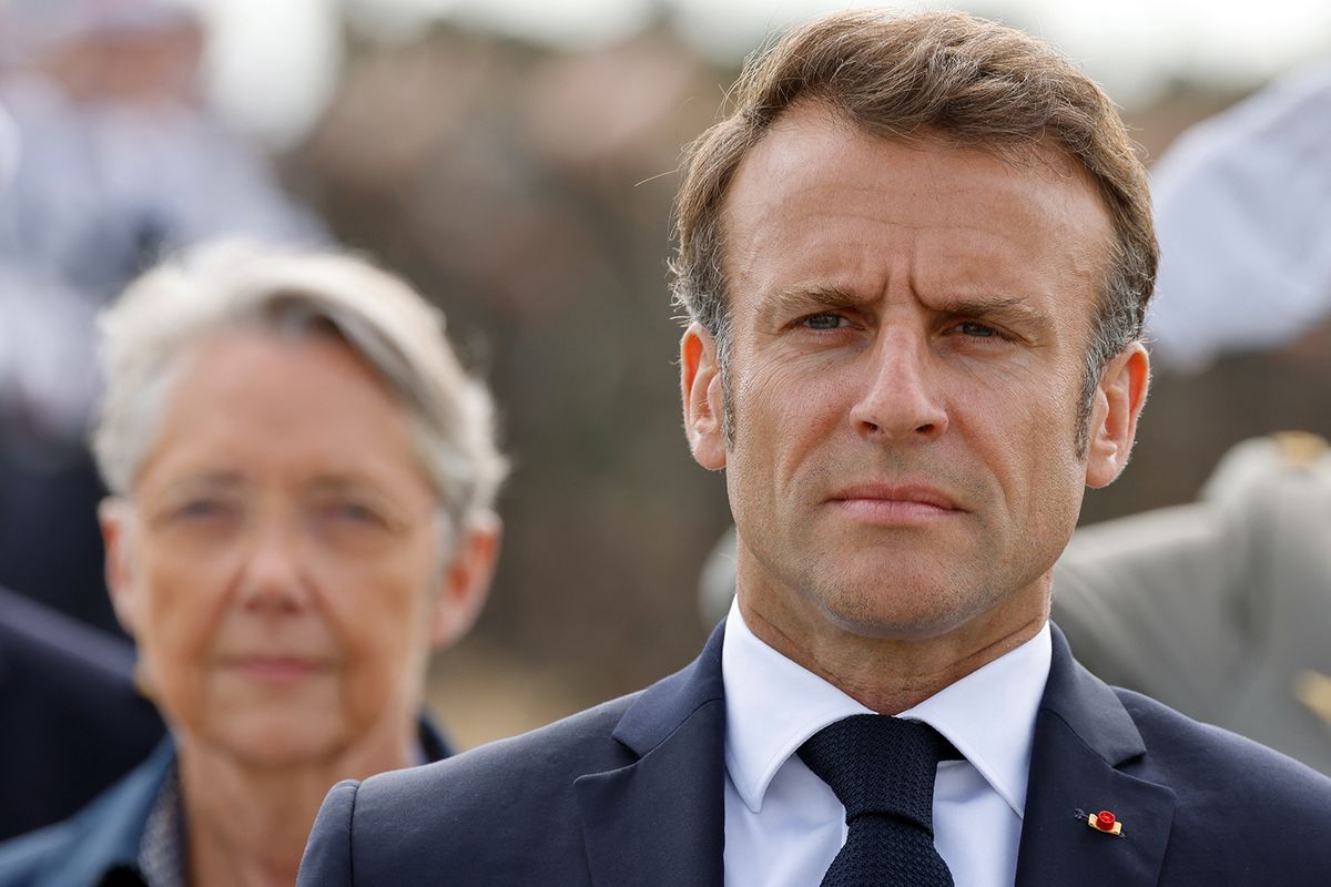French President Emmanuel Macron (R) and French Prime Minister Elisabeth Borne attend a ceremony in tribute to the 177 French members of the "Commando Kieffer" Fusiliers Marins commando unit who took part in the Normandy landings, as part of the 79th anniversary of the World War II "D-Day" Normandy landings, in Colleville-Montgomery, Normandy, on June 6, 2023. (Photo by Ludovic MARIN / POOL / AFP)