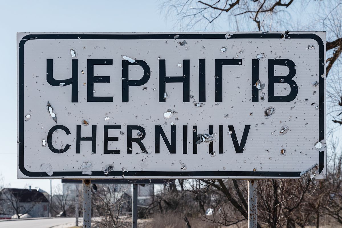 CHERNIHIV, UKRAINE - MARCH 19: A signpost of the beginning of the city of “Chernihiv” remains cut by shrapnel from artillery shells on March 19, 2023 in Chernihiv, Ukraine. On February 24, 2022, Russia launched a large-scale invasion of the territory of Ukraine in the Chernihiv Oblast from the side of Belarus. 