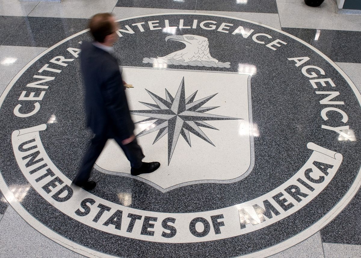 A man crosses the Central Intelligence Agency (CIA) seal in the lobby of CIA Headquarters in Langley, Virginia, on August 14, 2008. AFP PHOTO/SAUL LOEB (Photo by SAUL LOEB / AFP)